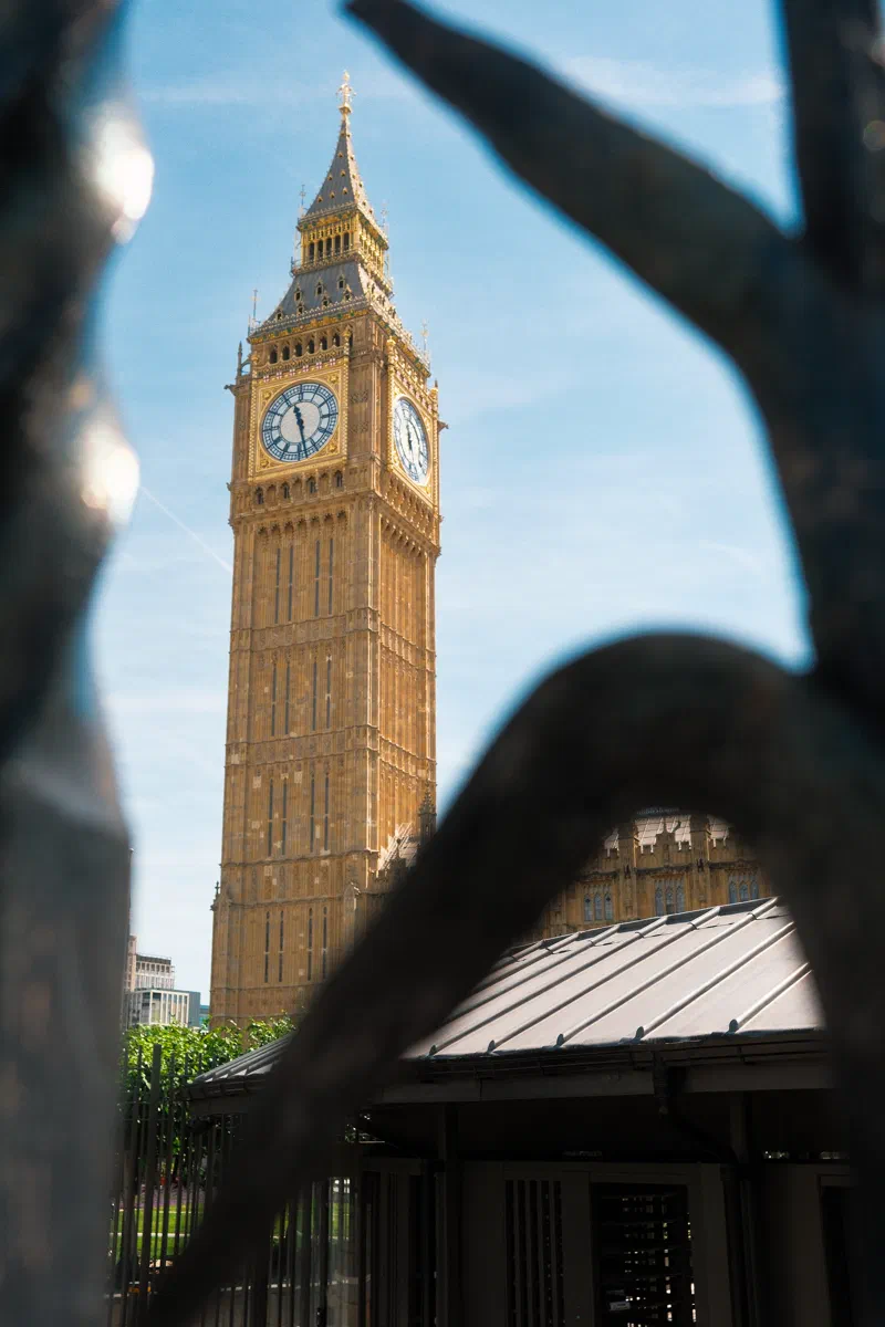 Elizabeth Tower framed through the wrought-iron railings of the Palace.