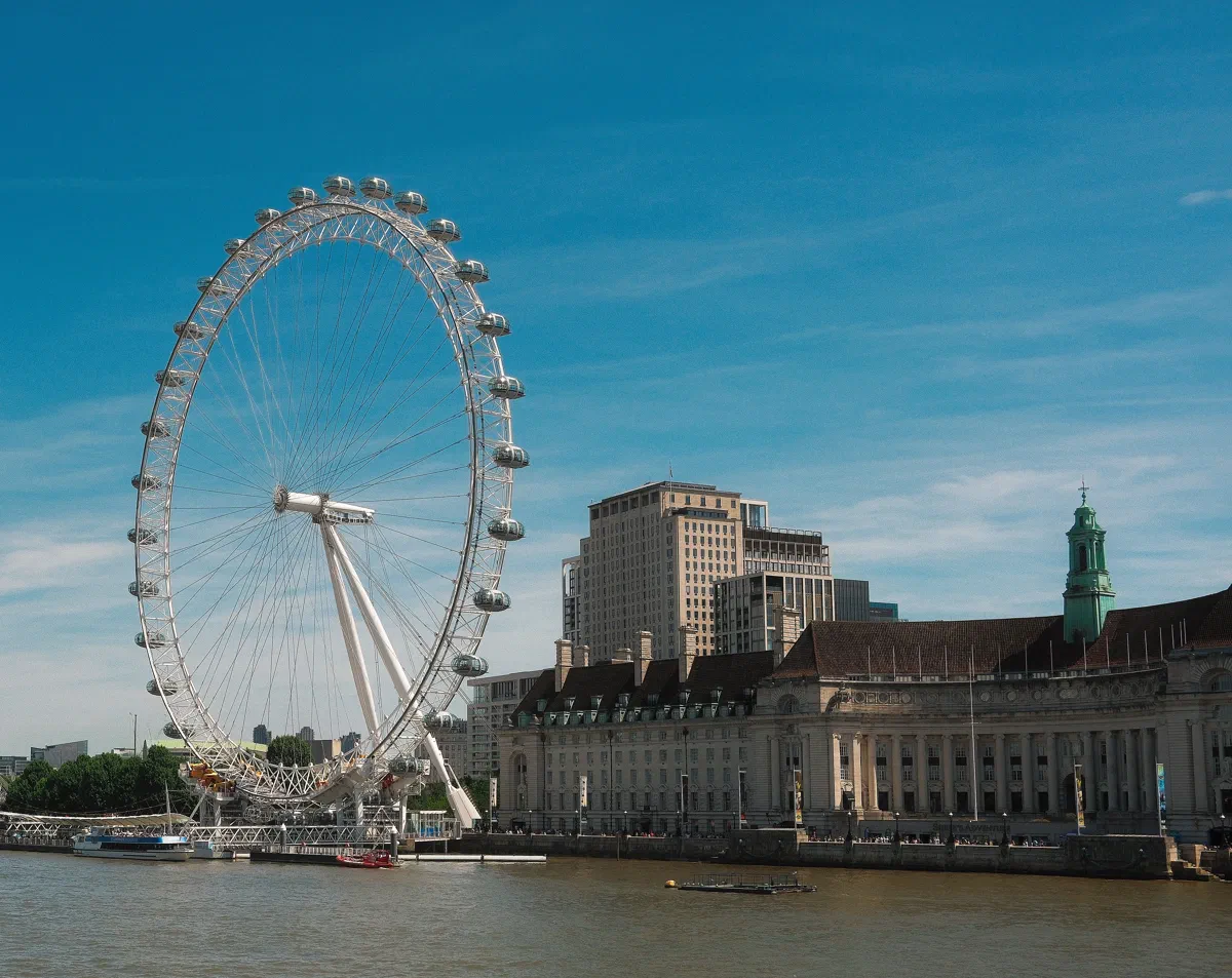 The London Eye turns beside County Hall on the South Bank.
